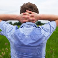 Man with hyperhidrosis sweating very badly under armpit in blue shirt because of hot weather. Travelling in asia thailand with backpacker